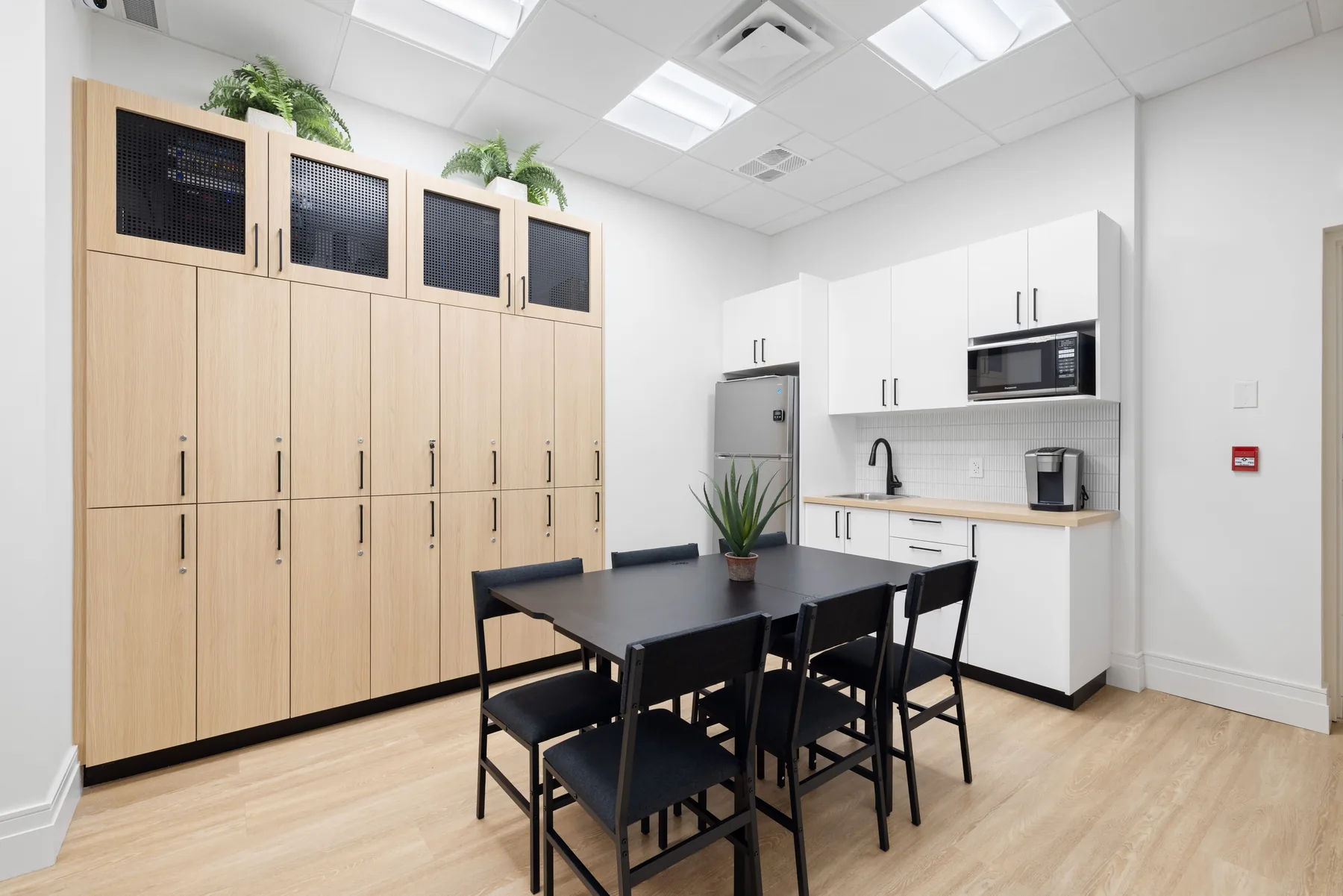 Staff room with lockers, table, and kitchenette