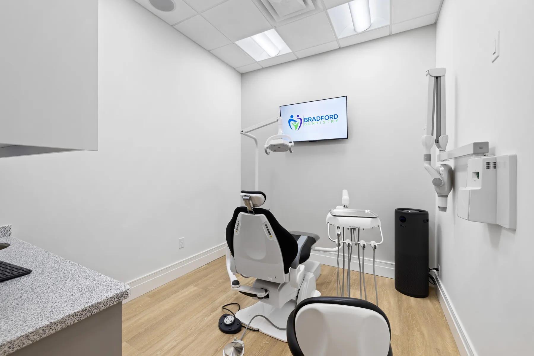 Modern dental operatory with patient chair and digital display